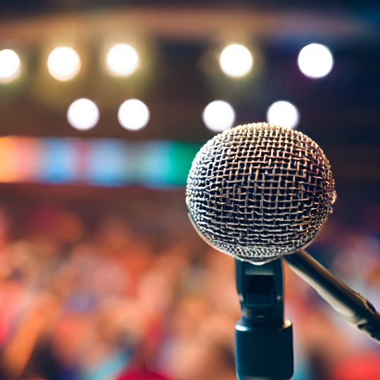 Microphone in a busy auditorium representing clear communication